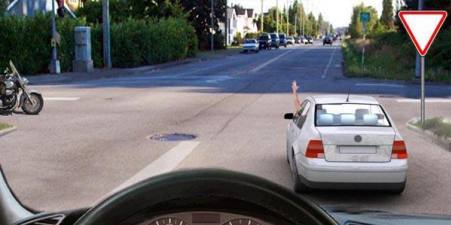 What does the car driver's hand signal tell you about?