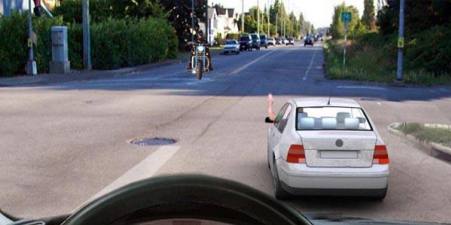 What does the car driver's hand signal tell you about?